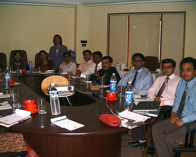Participants practising communication around a conference table