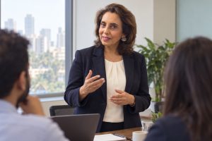 Illustration of Maya Daswani presenting calmly in a meeting